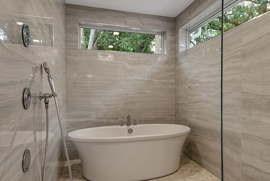 Modern bathroom with freestanding soaking tub and tiled walk-in shower by Northern Illinois Home Builders Association members